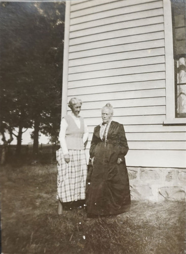 Two Woman Standing Outside Home