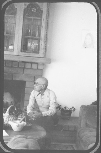 Charlie Ruiz Sitting Near Fireplace