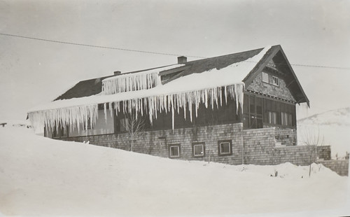 House Covered in Snow and Icicles