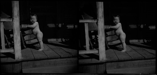 Child on porch with rocking chair