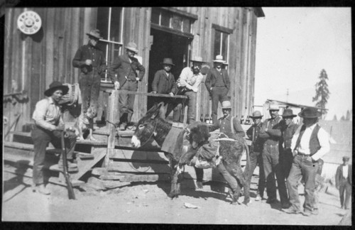 Hume Lake, Historic Individuals, Misc. Groups. Jack Clark with rifle, note bear on burro. Remarks: Hume Larson of Fresno states (1973) that this is not Hume Saloon but perhaps Millwood or Converse. Hu