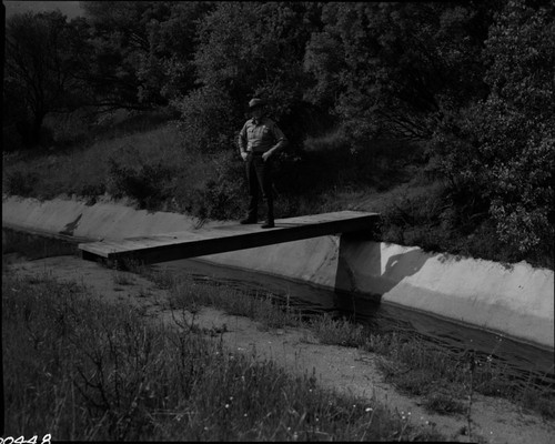 Buildings and Utilities, Flume. Dick Riegelhuth on bridge over flume. Cross-file to NPS Individuals