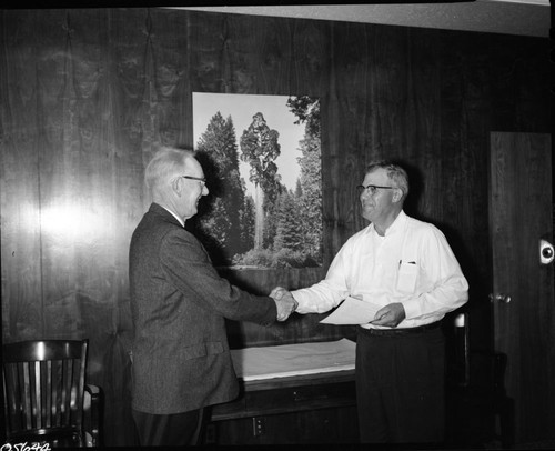 NPS Individuals, Arnold C. Quist receives award from Supt. Davis for excellence of service signed by Sec. Udall