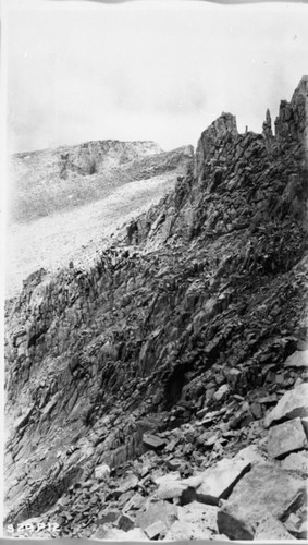 Construction, last pinnacles to be passed before reaching the gentle slope of loose rock leading to the top of Mt. Whitney. This is where construction work ceased for the season of 1929 about elev. 1