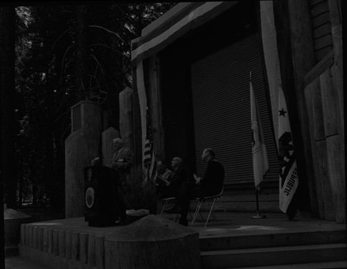 Dedications and Ceremonies, NPS Groups, Park Superintendents. 50th Anniversary of Park Service, Grant Grove Amphitheater. Newton B Drury (speaking), Supt. Frank Kowski, Eivind Scoyen, Father Richard