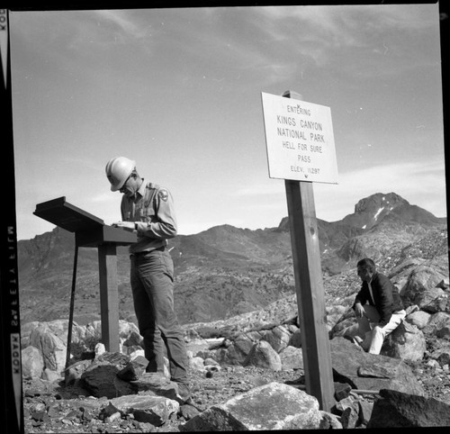 Signs, Placing new signs. NPS Individuals - Richard McLaren standing