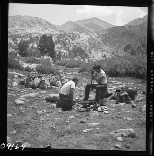 Backcountry cleanup, crew smashing cans