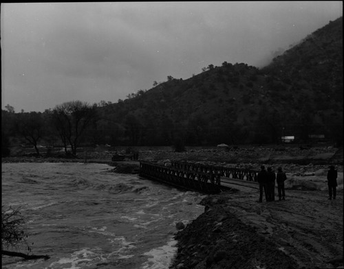 Wayne Alcorn, Middle Fork Kaweah River in Three Rivers (just upriver from site of present Chevron station). Floods and Storm damage. "Bailey Bridge" erected after flood. 560100