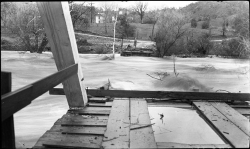 Flood and Storm Damage, Taylor Bridge washed out. Remarks: C.L. Taylor standing on the other side