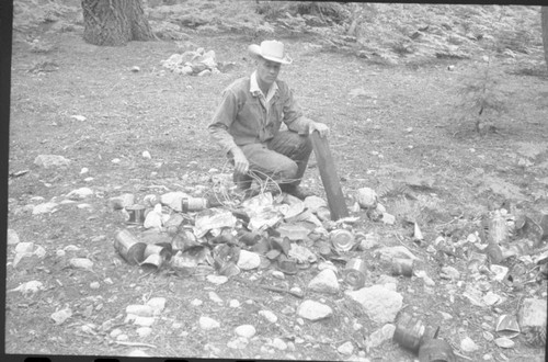 NPS Individual, Backcountry Cleanup, Lowell Sumner at trash dump at junction of trail to Charlotte Creek