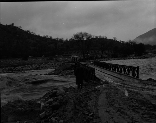 Wayne Alcorn, Middle Fork Kaweah River in Three Rivers (just upriver from site of present Chevron station). Floods and Storm damage. "Bailey Bridge" erected after flood. 560100