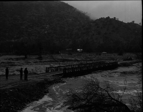 Wayne Alcorn, Middle Fork Kaweah River in Three Rivers (just upriver from site of present Chevron station). Floods and Storm damage. "Bailey Bridge" erected after flood. 560100