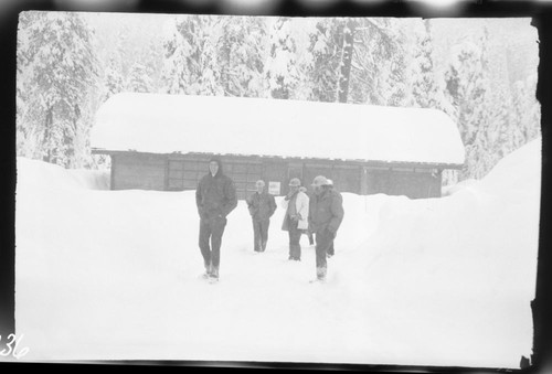 Record heavy snows. Snow at Lodgepole gas station. Larry Bancroft and Charlie Castro in foreground