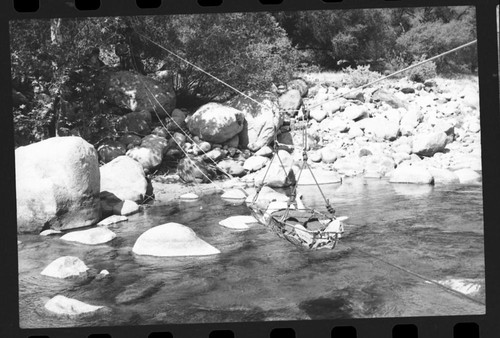 Training Activities, Ranger Activities, Interpretive Activities. River Rescue Demonstration. "Victim" in stretcher crossing river on cable