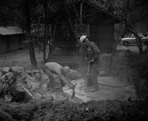 Buildings and Utilities, Foundation removal. Remarks: Rollie Cowle and youth from County Camp breaking up foundation of cabin east of Administration Building. N.P.S. Individuals