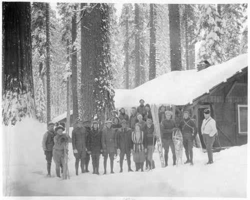 Skiing early skiers in Giant Forest. George Magley and wife in center. NPS Individuals. [8x10 print]