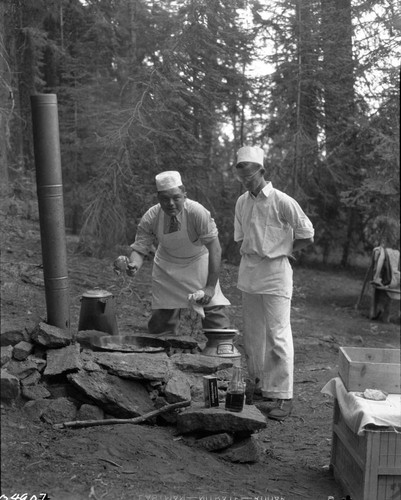 Historic Individuals, George Mauger and John Gabbert cooking steaks at picnic for Director Cammerer