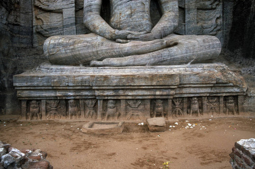 Gal Vihāra complex: Seated Buddha figure: Statue carved in rock: Torso: Throne: Vajras: Lions