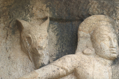 Isurumuniya, rock temple: north of shrine: sculpture of seated man and a horse
