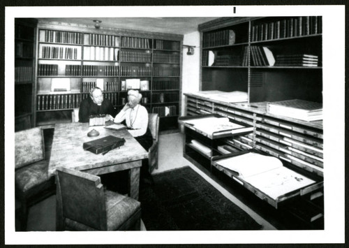 Ellen Browning Scripps with clergyman in library