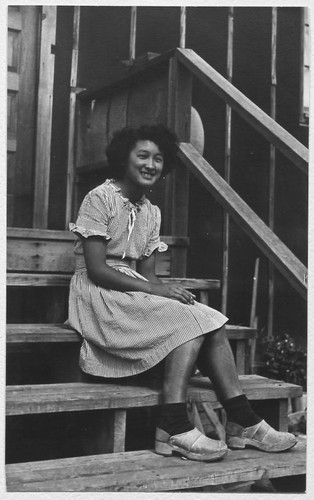 Young woman seated on steps