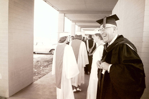 Robert J. Bernard with three graduates