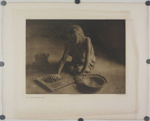 The potter mixing clay