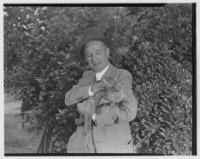 Edmund Heller and kinkajou "Teddy" at zoo