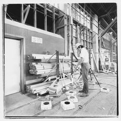 Worker cutting electrical cables at Speedspace Corporation, 920 Shiloh Road, Windsor, California, 1971