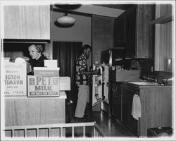 Peck family moving things into their kitchen, Santa Rosa, California, 1957