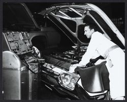 Tuning a car at Bishop Hansel Ford, Santa Rosa, California, 1963