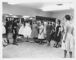 Girls of Conover School trying on clothes at Ceci's, Santa Rosa, California, 1960