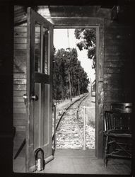 Looking out the door of a caboose of the Petaluma and Santa Rosa Railroad, Petaluma, California, 1937
