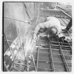 Construction worker welding forms for the second floor in the new Exchange Bank building, 545 Fourth Street, Santa Rosa, California, 1971