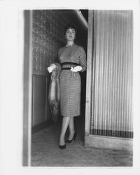 Mid-length dress with a diamond-checked pattern modeled in the "Dramatic Moods" fashion show in the Topaz Room, Santa Rosa, California, 1959