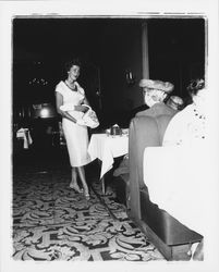 White calf-length dress modeled in the "Dramatic Moods" fashion show in the Topaz Room, Santa Rosa, California, 1959