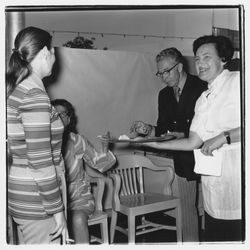 Catering staff person and attendees at the Zumwalt Chrysler-Plymouth Center Open House, Santa Rosa, California, 1971