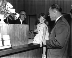 Jack Bernard and Roderick Bryan helping a young customer deposit her money at grand opening of Summit Savings, Sebastopol, California, September 30, 1967