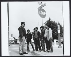 Unidentified policeman talking to a group of boys at corner of Sonoma Avenue and Doyle Park Drive, Santa Rosa, California, 1972