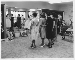 Girls of Conover School trying on clothes at Ceci's, Santa Rosa, California, 1960