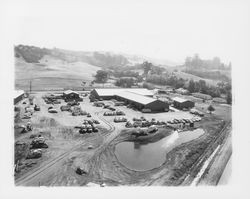 Aerial view of graded equipment yard and pond at the rear of Stevenson Equipment Company Incorporated, Santa Rosa, California, 1964