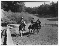 Horseback riders gallop in a corral at Palomino Lakes, Cloverdale, California, 1961