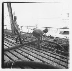 Construction workers pumping concrete into forms for the second floor in the new Exchange Bank building, 545 Fourth Street, Santa Rosa, California, 1971