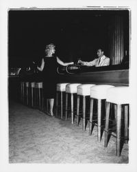 Sleeveless black sack dress modeled in the "Dramatic Moods" fashion show in the Topaz Room, Santa Rosa, California, 1959