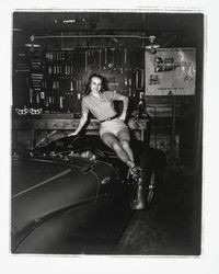 Diane Romero, Miss Sonoma County posing atop a foreign sports car for S.C.C.A. race publicity, Santa Rosa, California, 1957