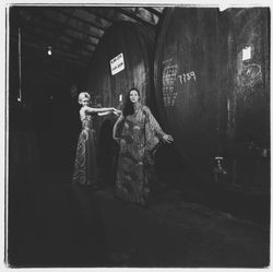 Two Miss Sonoma County candidates modeling long, patterned dresses in front of fermentation vats at a fashion show at Korbel Winery, Guerneville, California, 1971