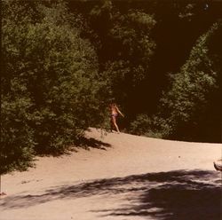 Woman entering the woods near Guerneville Beach, Guerneville, California, 1970