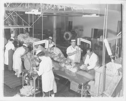 Workers bagging chickens at the California Poultry, Incorporated, Fulton, California, 1958