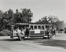 California Street Cable Car of San Francisco with waving passengers in front of Analy High School, Sebastopol, California, October 1967