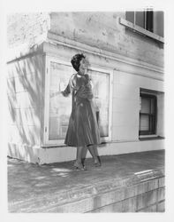 Velvet cocktail dress modeled on the ledge of the Sonoma County Courthouse in downtown Santa Rosa, California, 1959